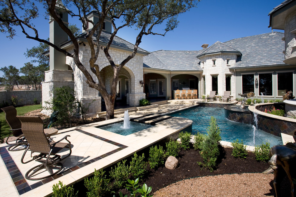 Example of a mid-sized classic courtyard custom-shaped pool fountain design in Austin with decking