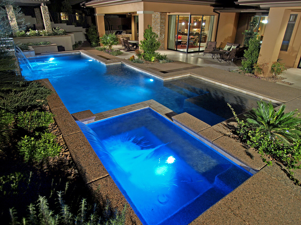 Design ideas for a large traditional back rectangular lengths hot tub in Las Vegas with concrete slabs.