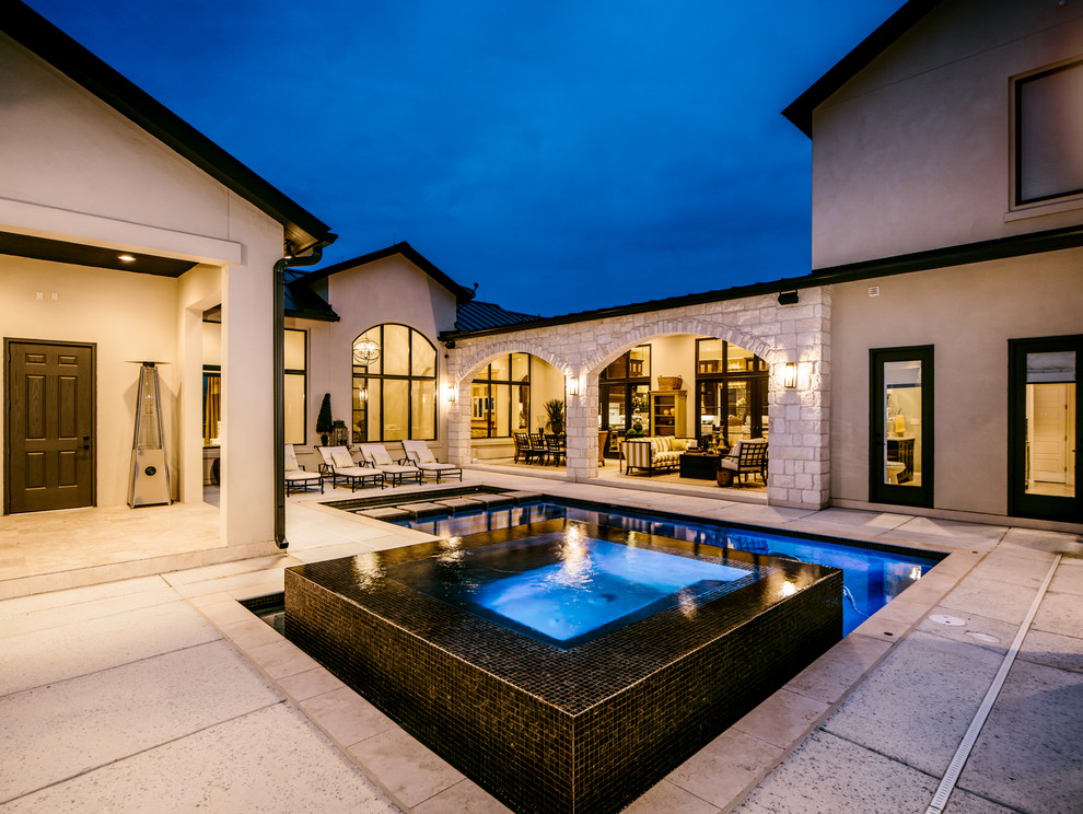 Large transitional courtyard custom-shaped and concrete lap hot tub photo in Austin