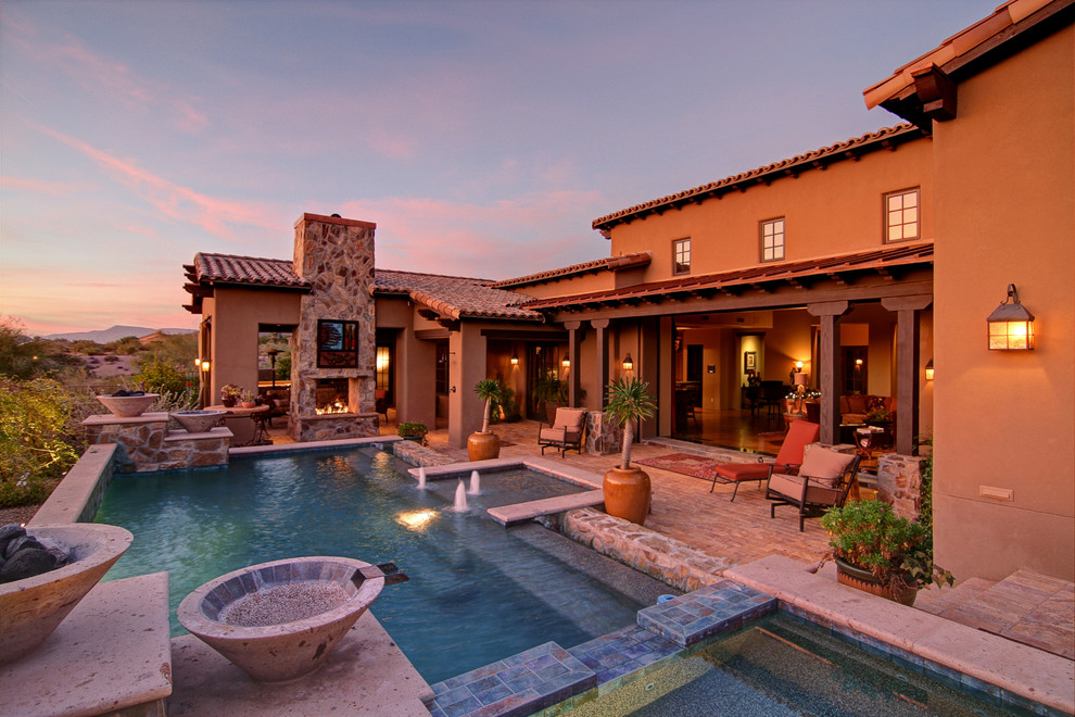 Mittelgroßer Mediterraner Pool hinter dem Haus in rechteckiger Form mit Natursteinplatten in Phoenix