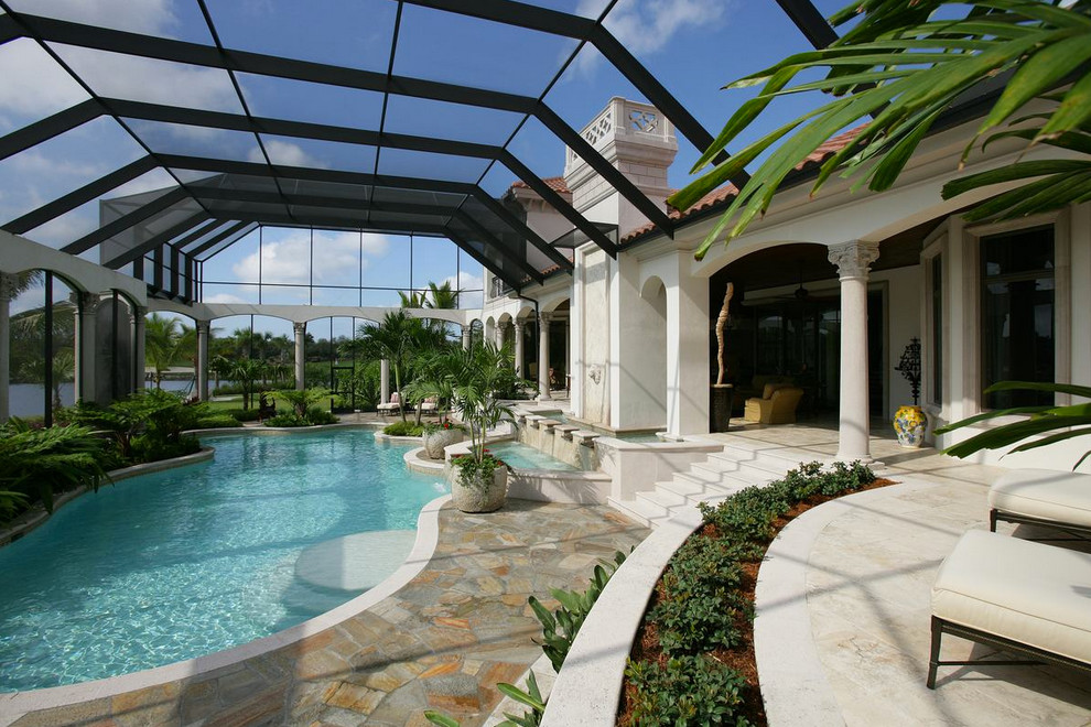 Mediterranean back custom shaped swimming pool in Miami with a pool house.
