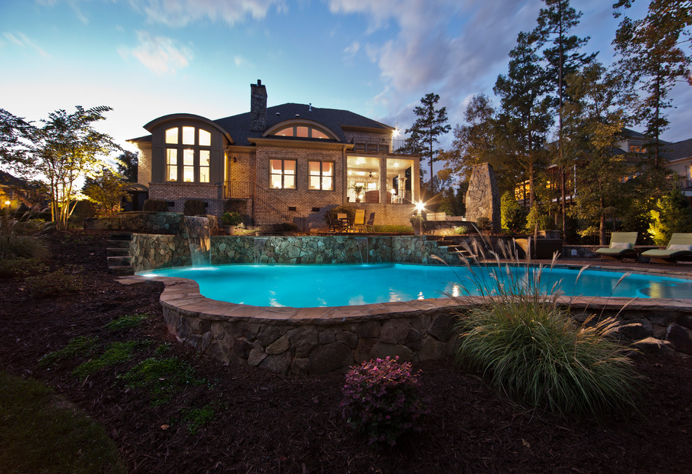 Pool - contemporary stone and custom-shaped pool idea in Charlotte
