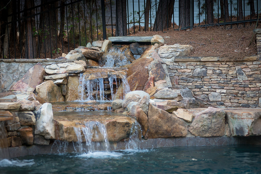 Mid-sized mountain style backyard custom-shaped pool fountain photo in Other