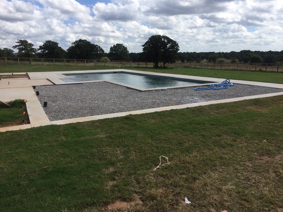 Large minimalist backyard concrete and custom-shaped lap hot tub photo in Oklahoma City