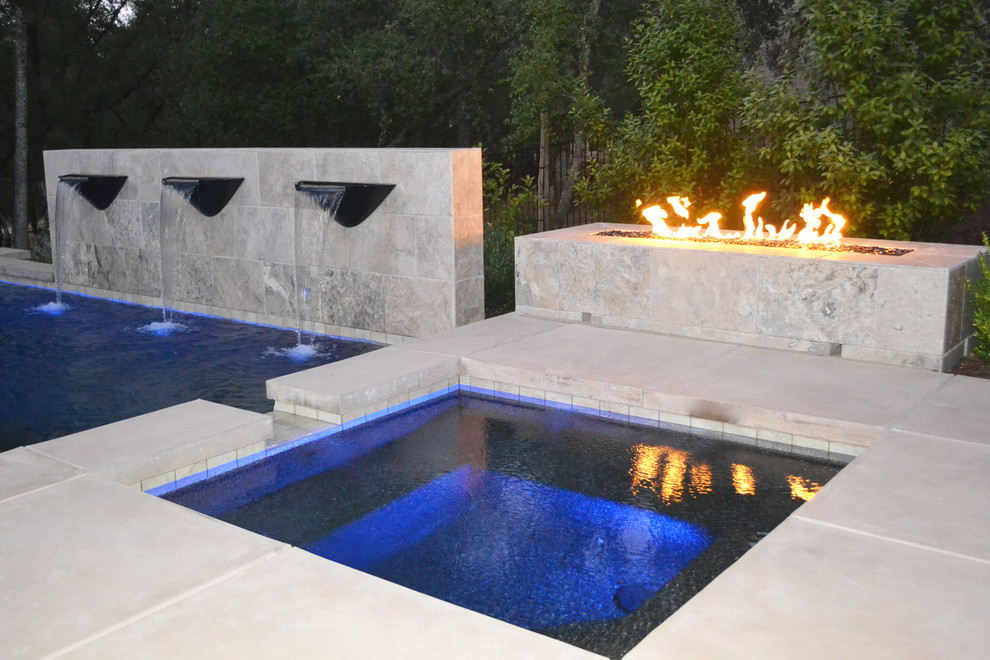 Pool fountain - mid-sized contemporary backyard stamped concrete and custom-shaped pool fountain idea in Sacramento