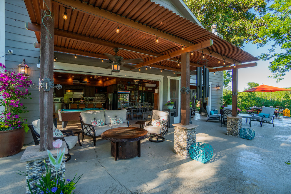 Design ideas for an expansive world-inspired back patio in Houston with tiled flooring.