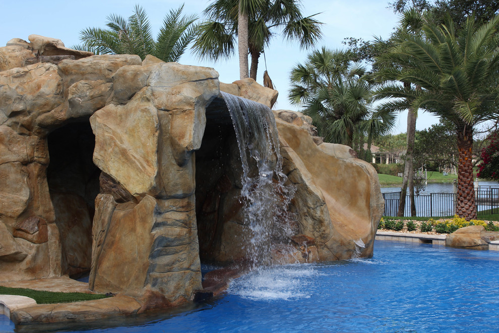 Свежая идея для дизайна: огромный бассейн произвольной формы на заднем дворе в морском стиле с фонтаном и покрытием из каменной брусчатки - отличное фото интерьера