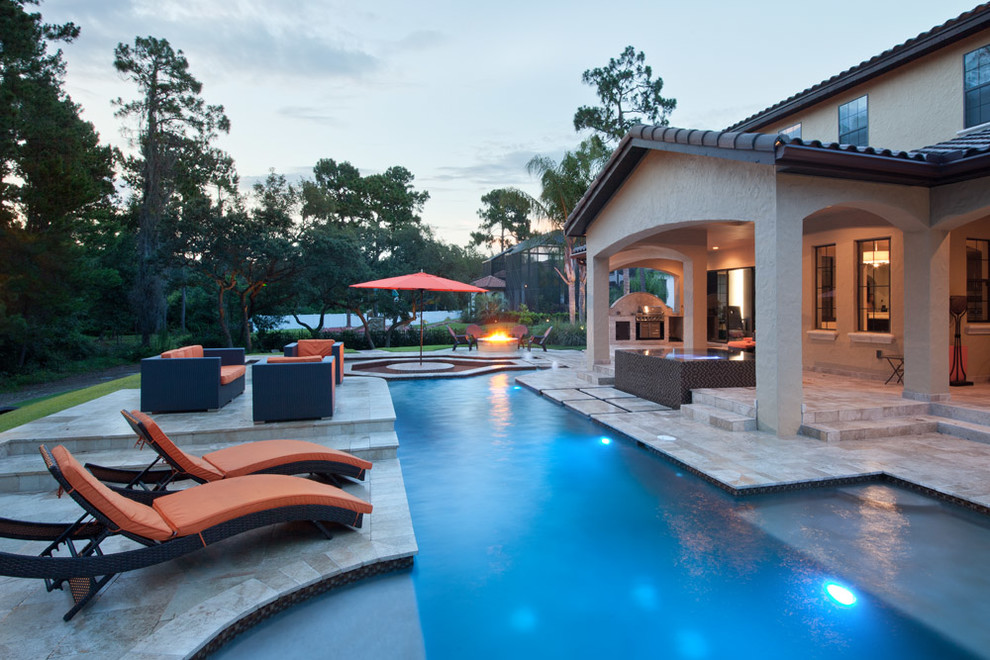 Mid-sized island style backyard stone and rectangular lap hot tub photo in Orlando