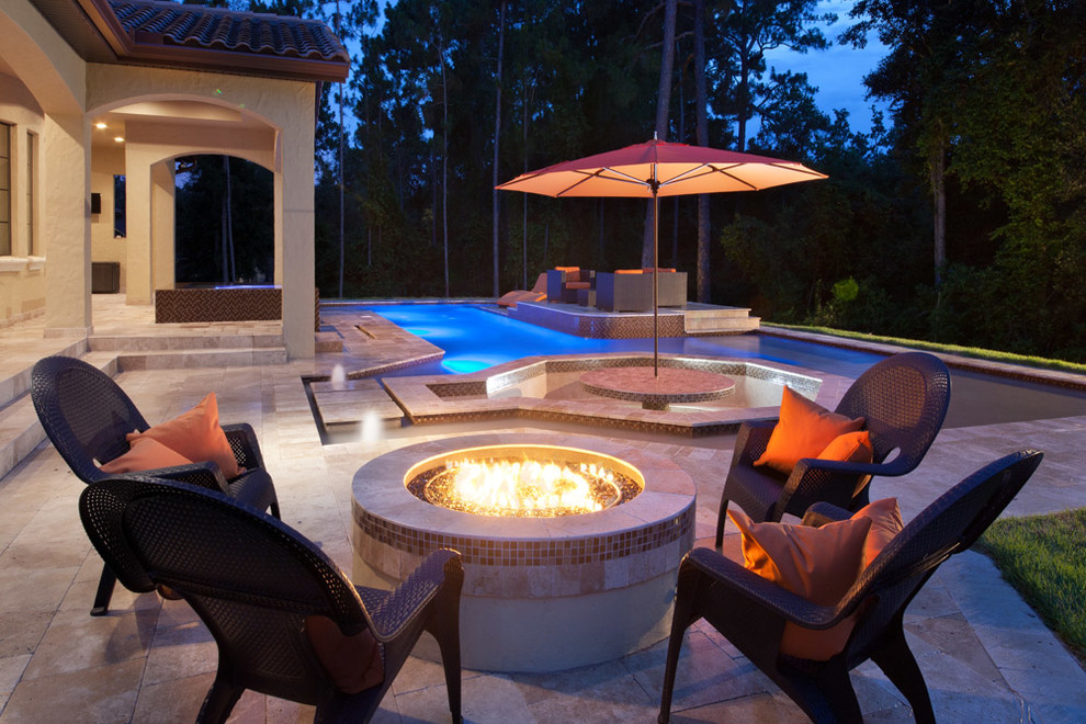 Inspiration for a mid-sized tropical backyard stone patio remodel in Orlando