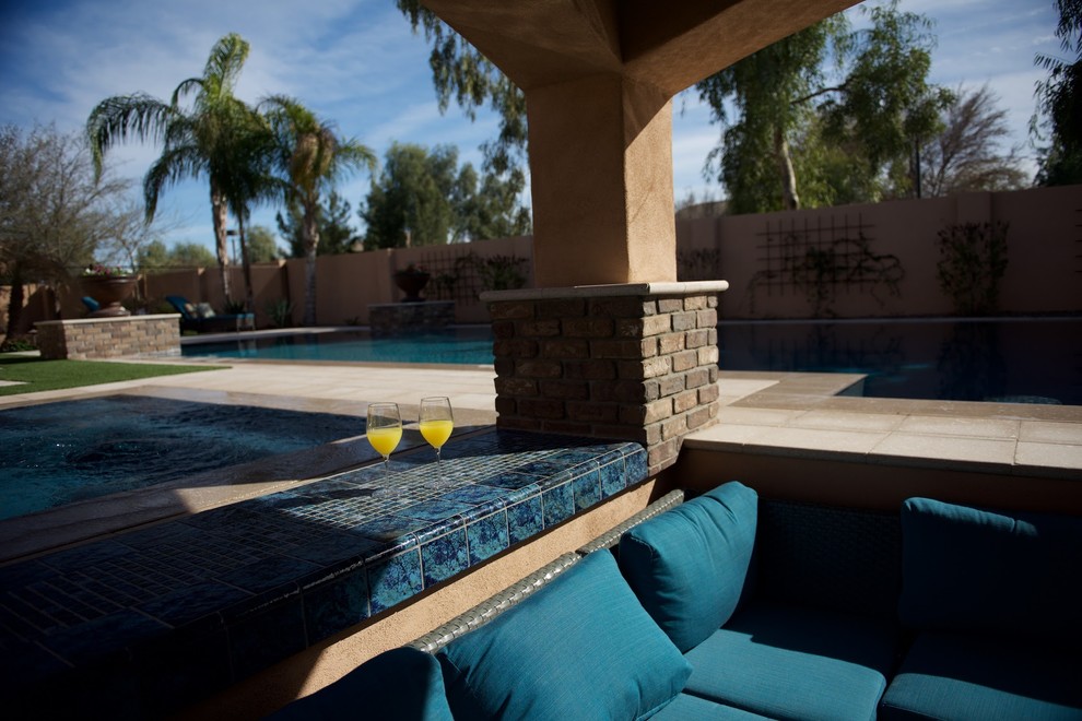 Exemple d'un grand Abris de piscine et pool houses arrière tendance rectangle avec des pavés en pierre naturelle.