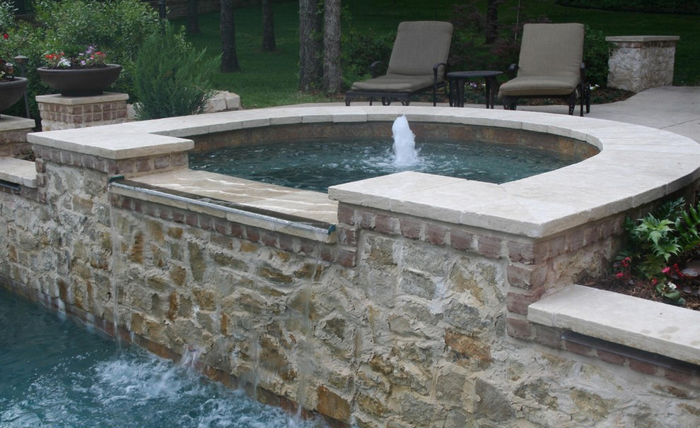 Inspiration for a back rectangular swimming pool in Dallas with a pool house and natural stone paving.