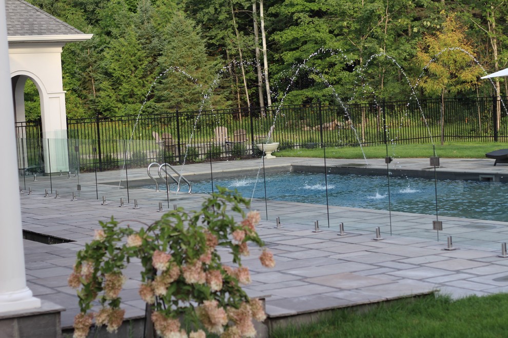 Großes Modernes Sportbecken hinter dem Haus in rechteckiger Form mit Wasserspiel und Stempelbeton in Ottawa