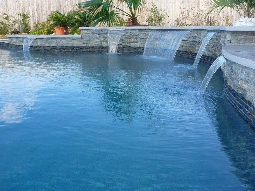 Photo of a contemporary back custom shaped swimming pool in Sacramento with concrete slabs.