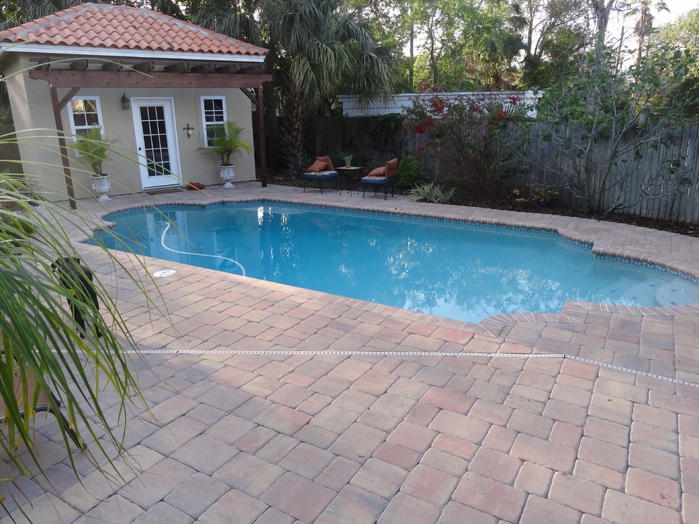 Pool - mid-sized traditional backyard custom-shaped pool idea in Jacksonville