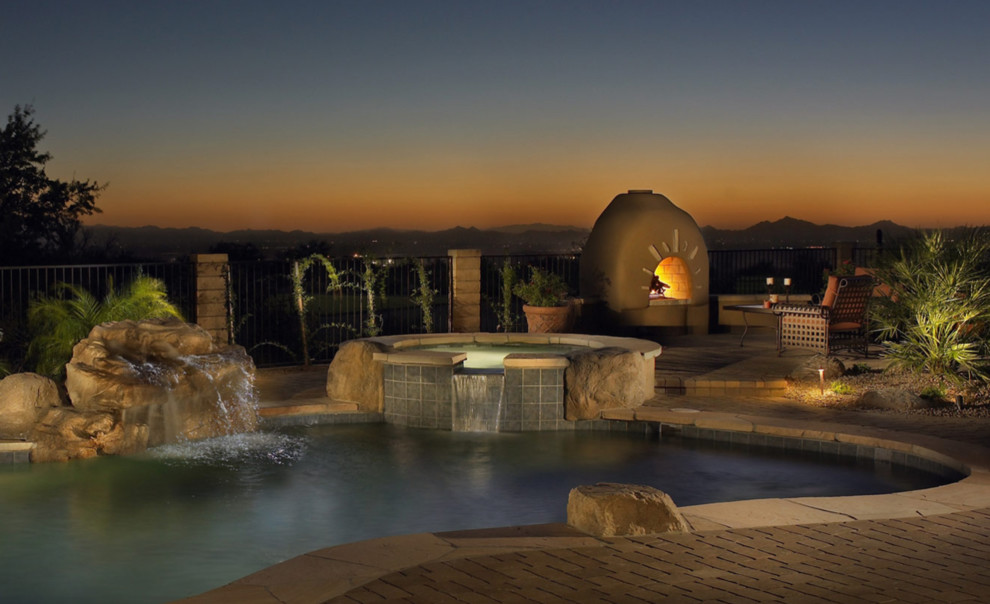 Hot tub - mid-sized southwestern backyard concrete paver and custom-shaped hot tub idea in Phoenix