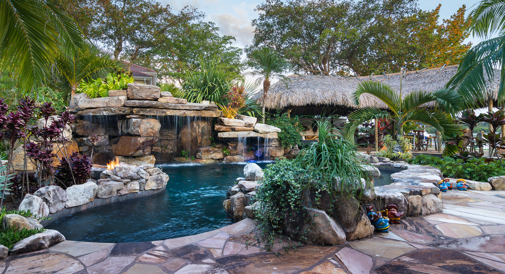 Custom Rock Waterfall Pool with Stone Grotto, Stream and Tiki Hut Tropical Pool Tampa by