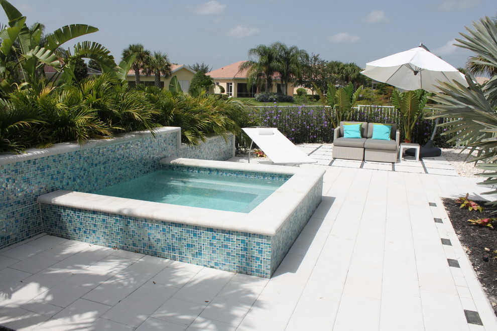 Idee per una piccola piscina fuori terra moderna rettangolare dietro casa con una vasca idromassaggio e pavimentazioni in cemento