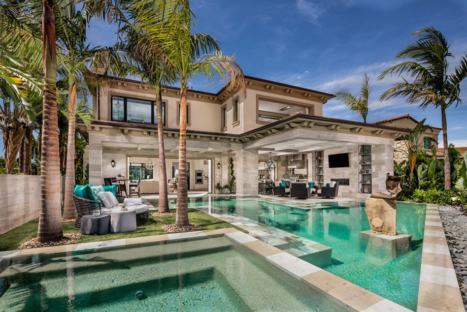 Inspiration for a mid-sized backyard tile and custom-shaped pool remodel in Orange County