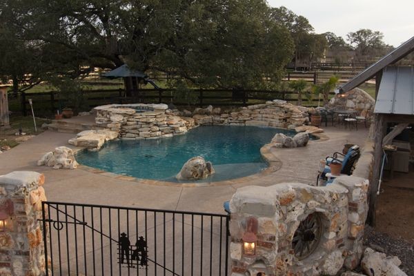 Pool - farmhouse backyard custom-shaped pool idea in Austin
