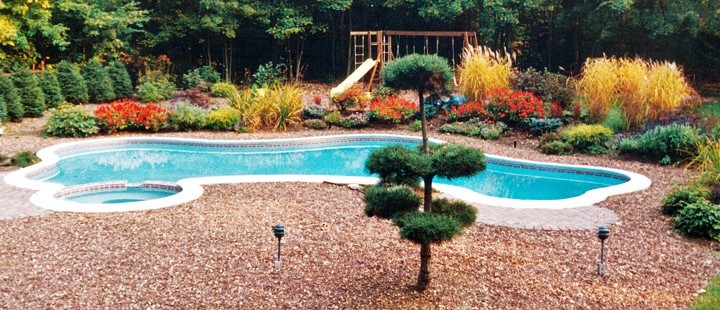 Inspiration for a large modern back custom shaped hot tub in New York with stamped concrete.