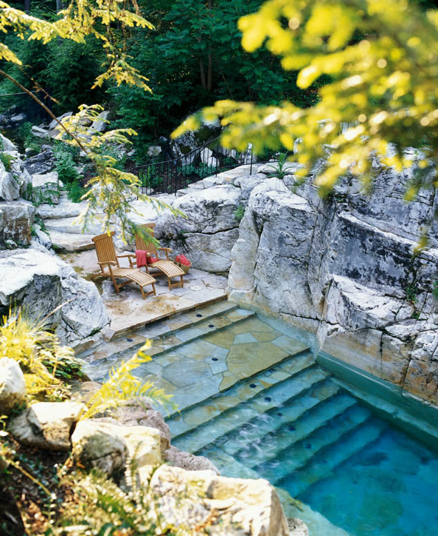 Inspiration for a large modern backyard stamped concrete and custom-shaped pool fountain remodel in New York