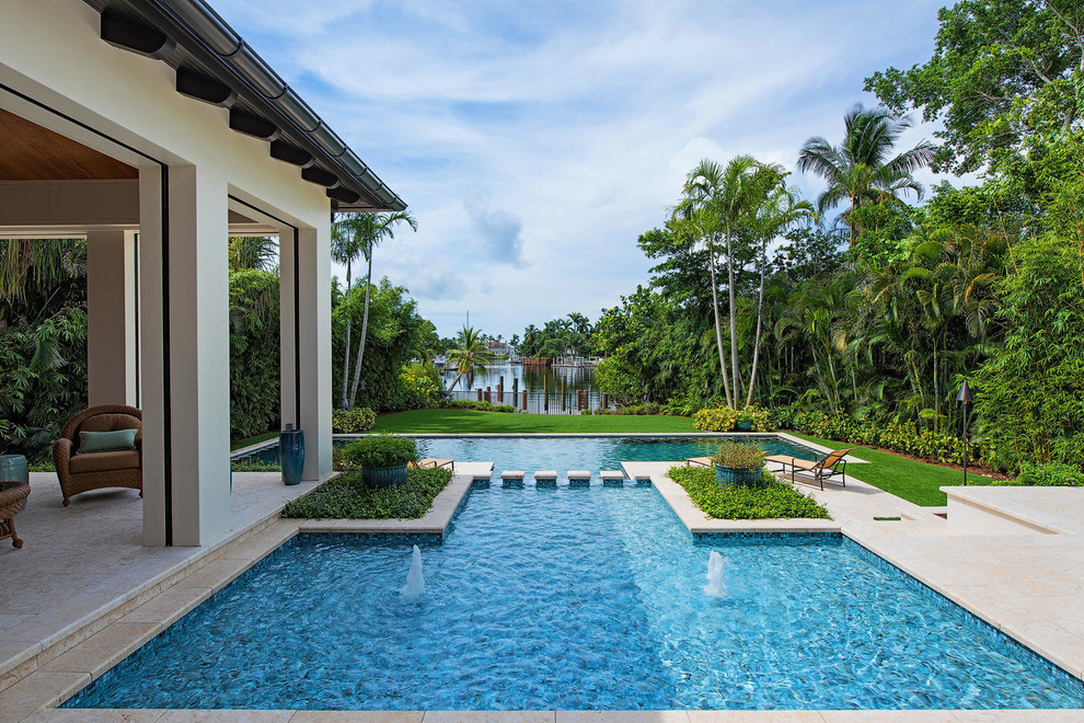 Inspiration for a large transitional backyard tile and custom-shaped infinity hot tub remodel in Miami