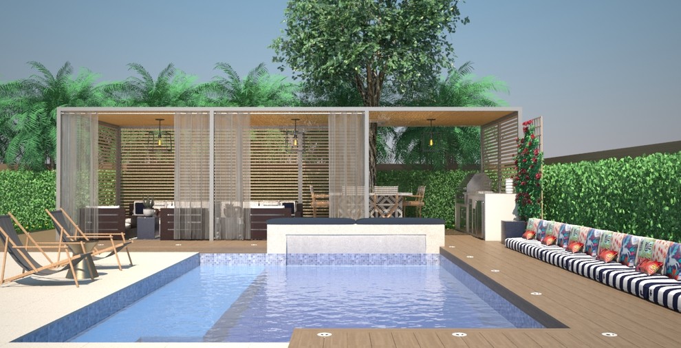 Modelo de piscina con tobogán alargada contemporánea grande rectangular en patio trasero con adoquines de piedra natural