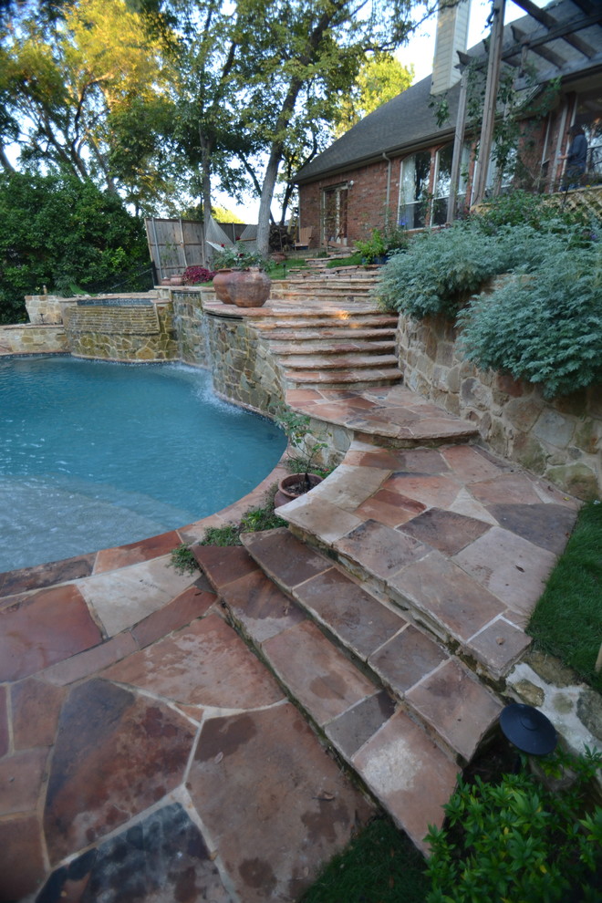 Example of a large mountain style backyard stone and custom-shaped natural pool fountain design in Dallas