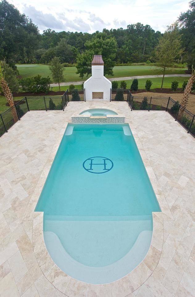 Ispirazione per una piscina naturale classica personalizzata di medie dimensioni con pavimentazioni in pietra naturale e una vasca idromassaggio