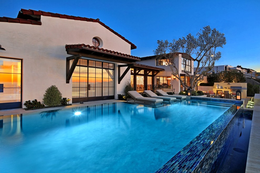 Inspiration for a medium sized mediterranean back infinity swimming pool in Orange County.