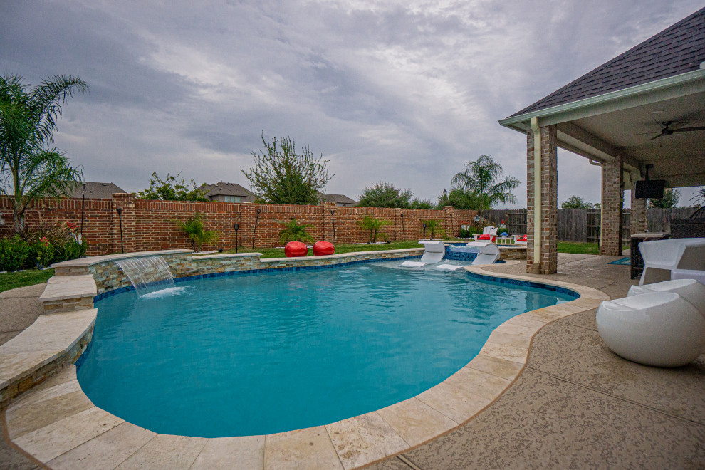 Mid-sized island style backyard custom-shaped pool photo in Houston