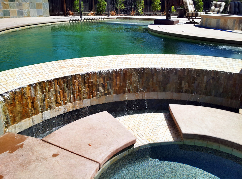 Hot tub - large mediterranean backyard concrete and custom-shaped infinity hot tub idea in Sacramento