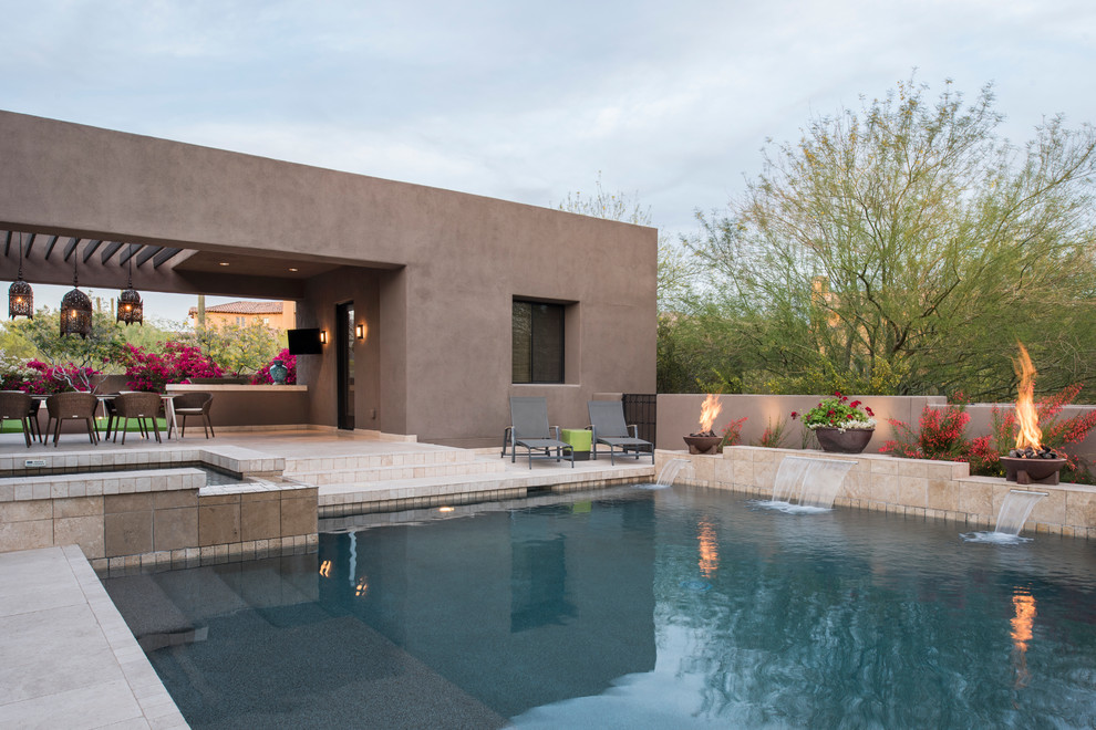 Inspiration for a southwestern backyard rectangular pool fountain remodel in Phoenix