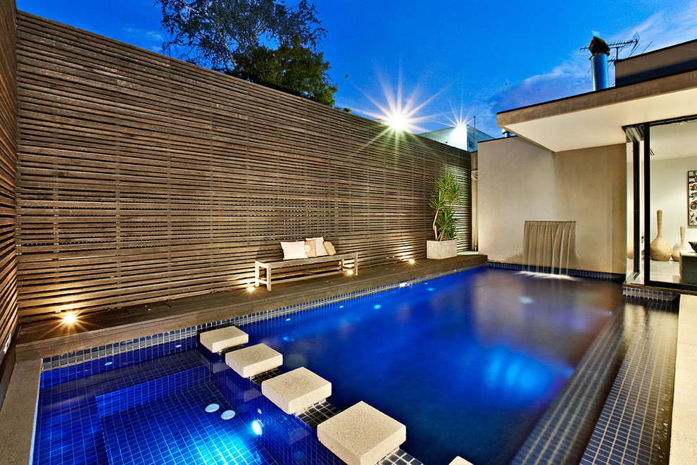 Medium sized contemporary back rectangular swimming pool in Melbourne with fencing.