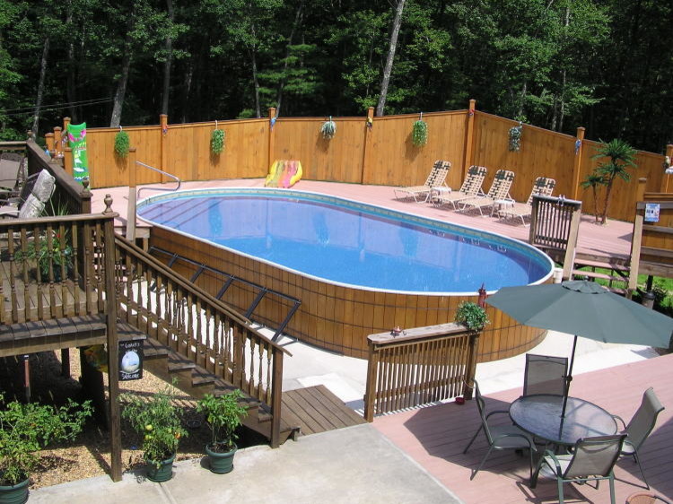 Pool - mediterranean backyard concrete aboveground pool idea in New York