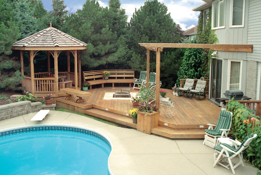 This is an example of a large modern back custom shaped swimming pool in Toronto with decking.