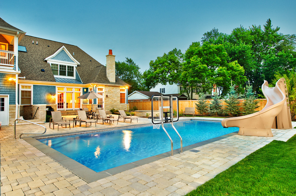 Inspiration for a mid-sized timeless backyard concrete paver and rectangular lap hot tub remodel in Chicago