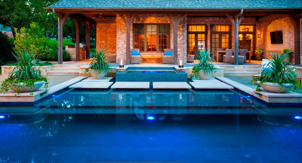 Large minimalist backyard stone and custom-shaped hot tub photo in Dallas