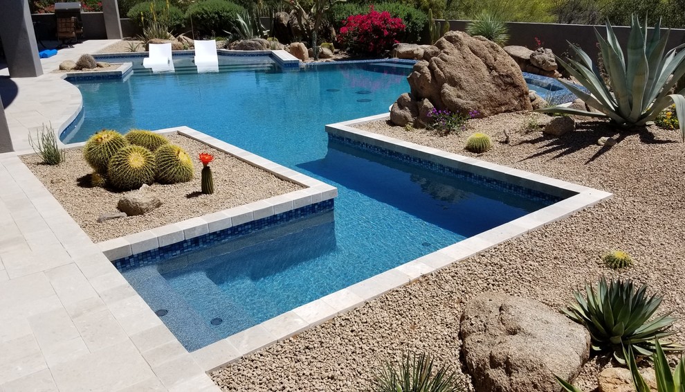 Inspiration for a large contemporary back custom shaped lengths swimming pool in Phoenix with concrete paving.