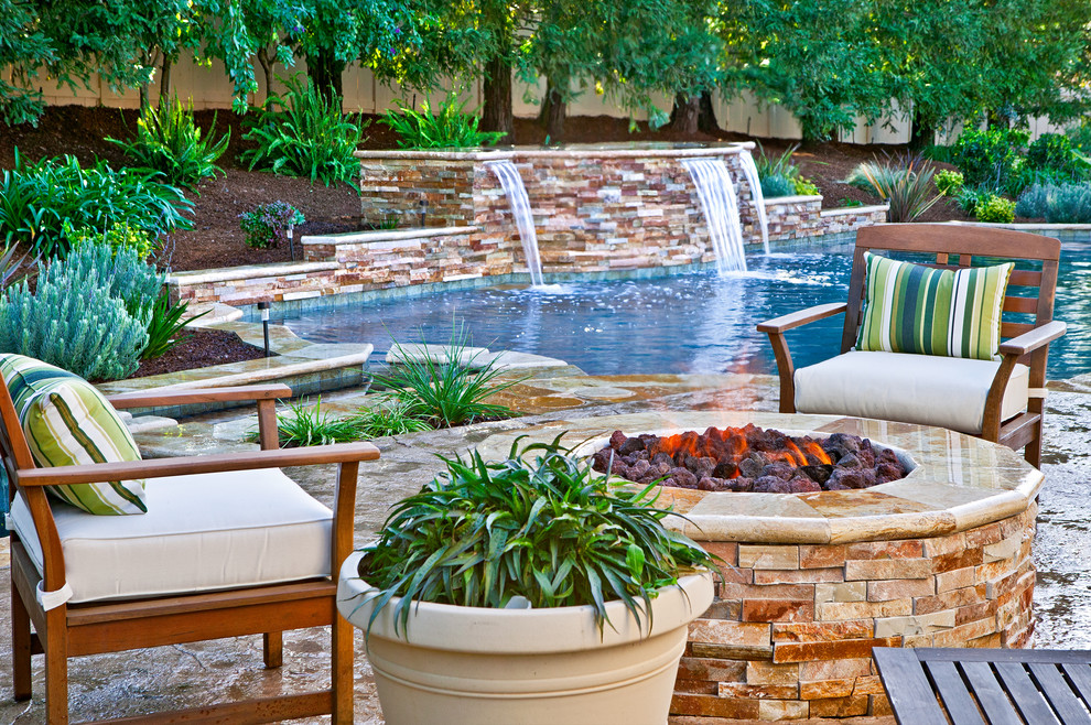 Mid-sized elegant backyard stamped concrete and custom-shaped pool fountain photo in San Diego