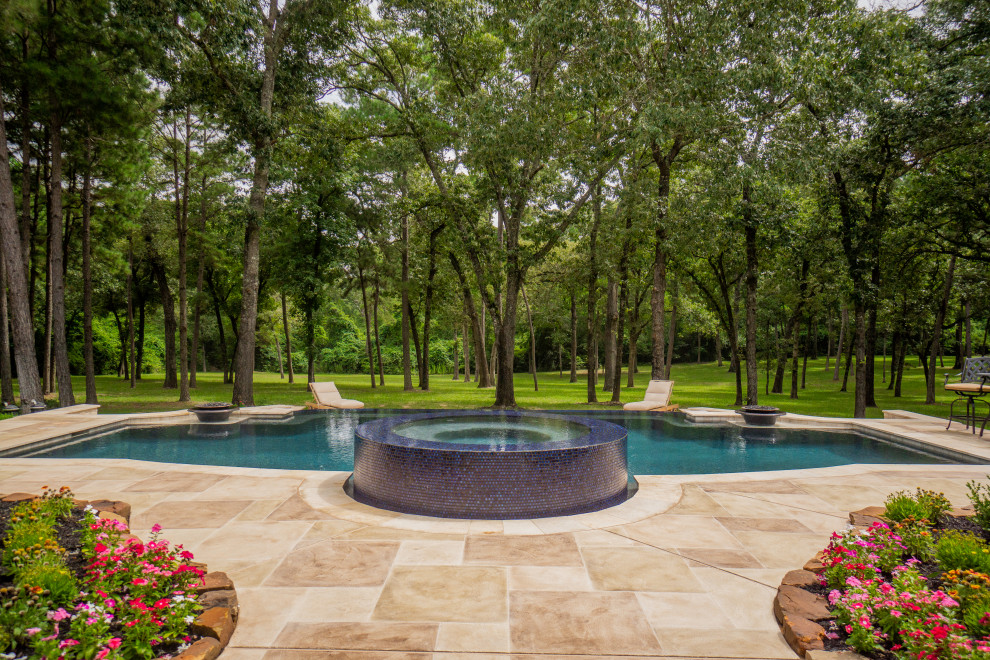 Photo of an expansive contemporary back custom shaped swimming pool in Houston with decking.