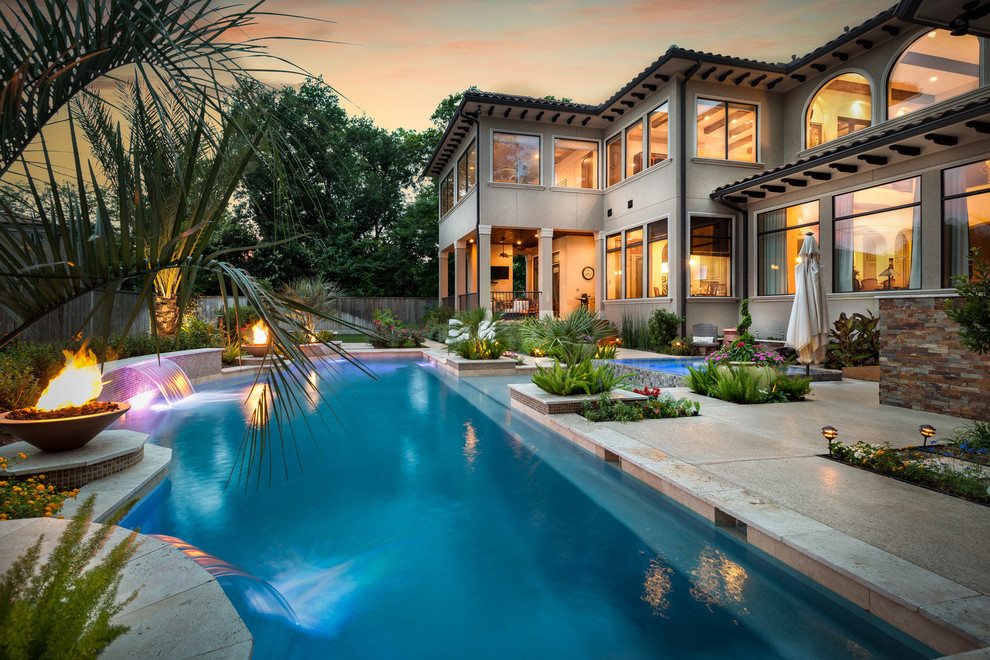 Inspiration for a large mediterranean back custom shaped swimming pool in Houston.