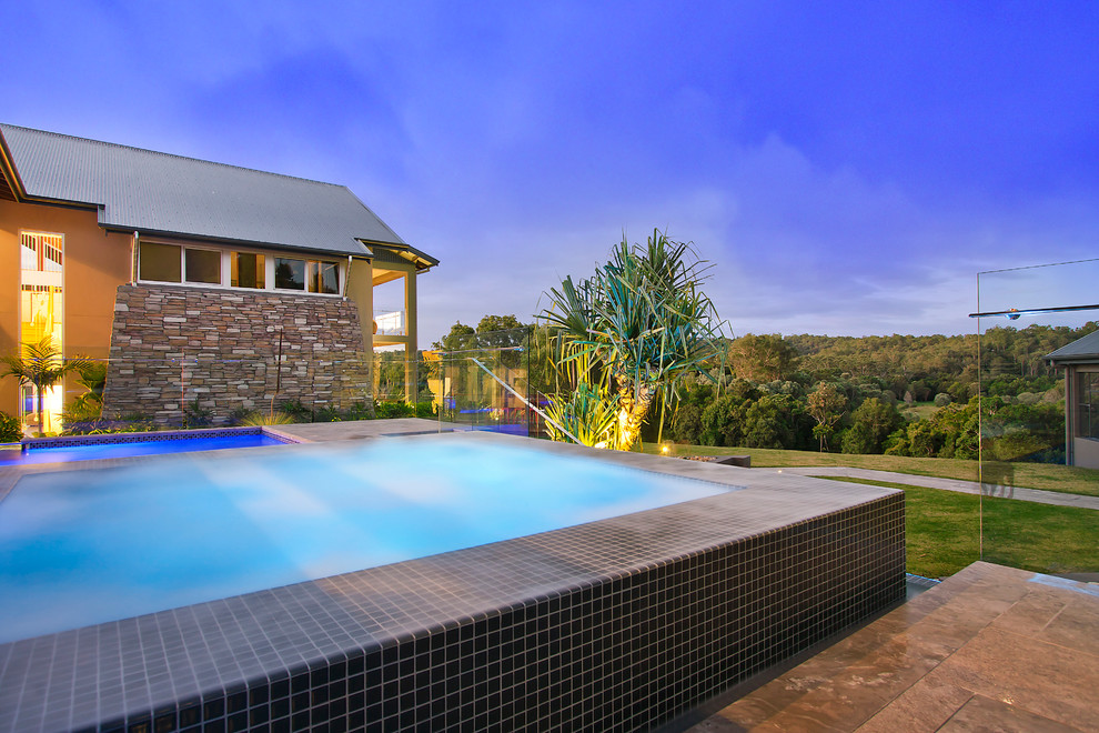 This is an example of a small contemporary back rectangular swimming pool in Brisbane with fencing.