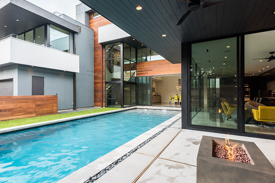 Pool - large modern courtyard concrete paver and rectangular lap pool idea in Houston