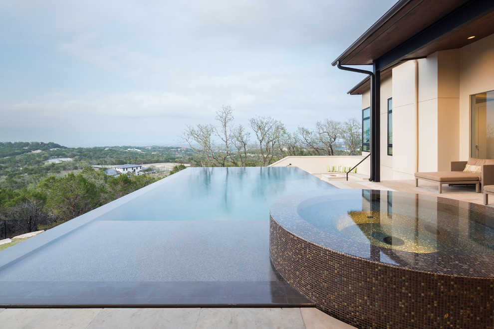 Pool - contemporary backyard rectangular pool idea in Austin