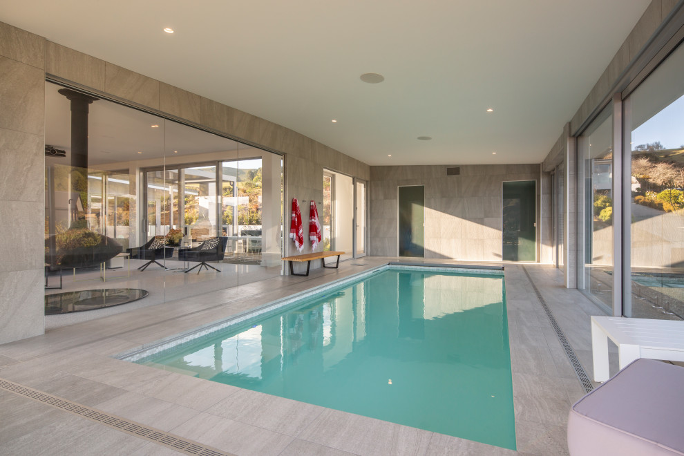 Стильный дизайн: большой естественный, прямоугольный бассейн в доме в стиле модернизм с домиком у бассейна - последний тренд