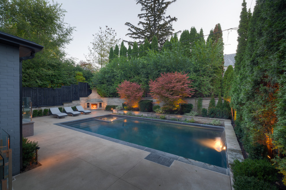 Design ideas for a large classic back rectangular swimming pool in Other with a water feature.