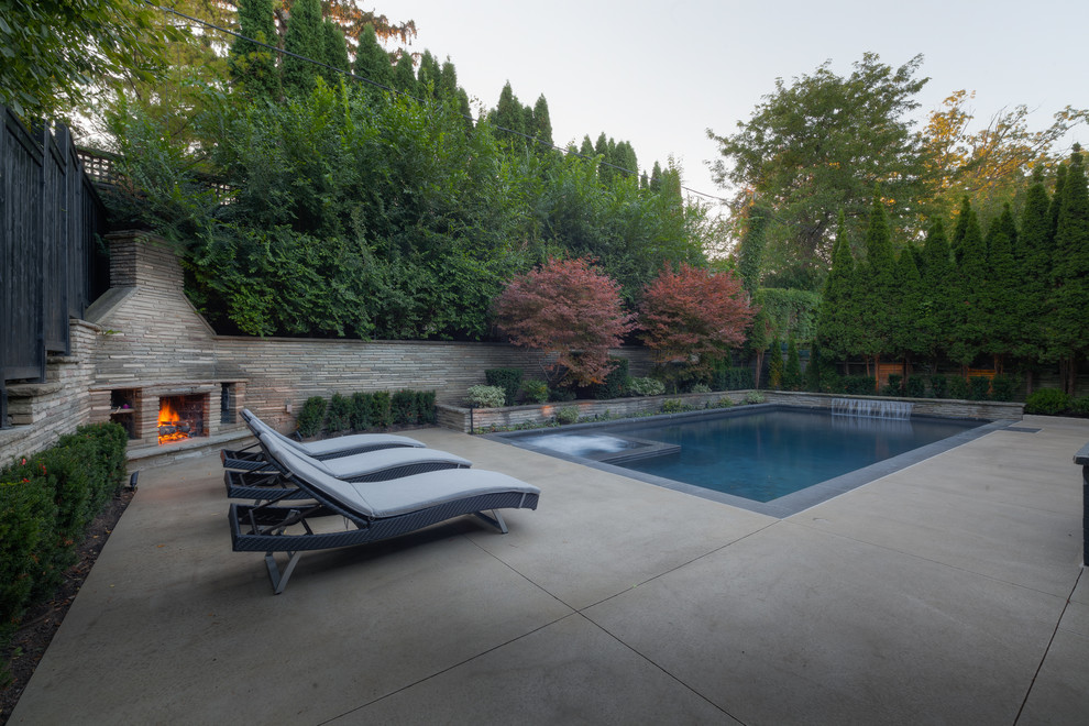 Pool fountain - large traditional backyard rectangular pool fountain idea in Other