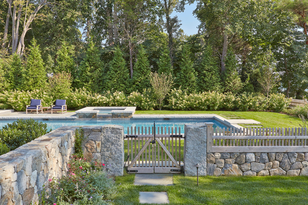 Design ideas for a medium sized classic side rectangular hot tub in Boston with natural stone paving.