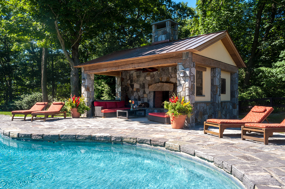 Pool - large traditional backyard stone and custom-shaped pool idea in New York